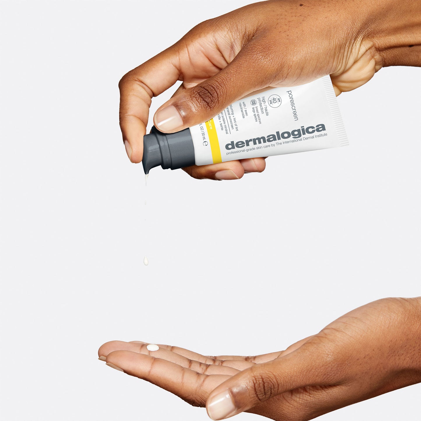 Woman dispensing Porescreen SPF 40 into hands using the pump