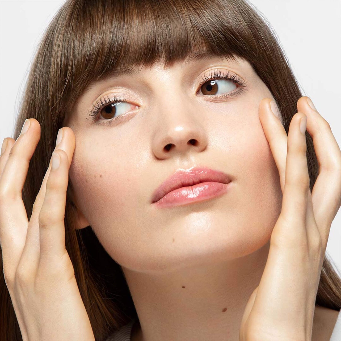 Woman applying awaken peptide eye gel to under eye