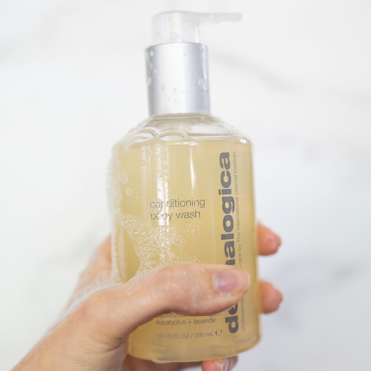Dermalogica Body Conditioning Wash bottle in hand with bubbles